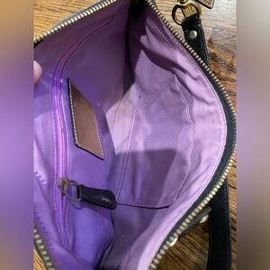 This is a black coach bag handheld